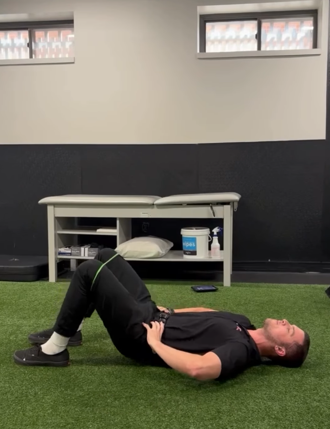 Exercise physiologist Pat Furphy demonstrating a glute bridge for back pain