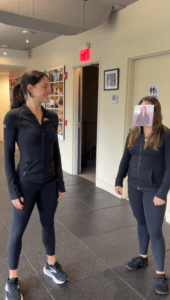Physical therapist wearing a photo of a colleague’s face in a joke about choosing a physical therapist